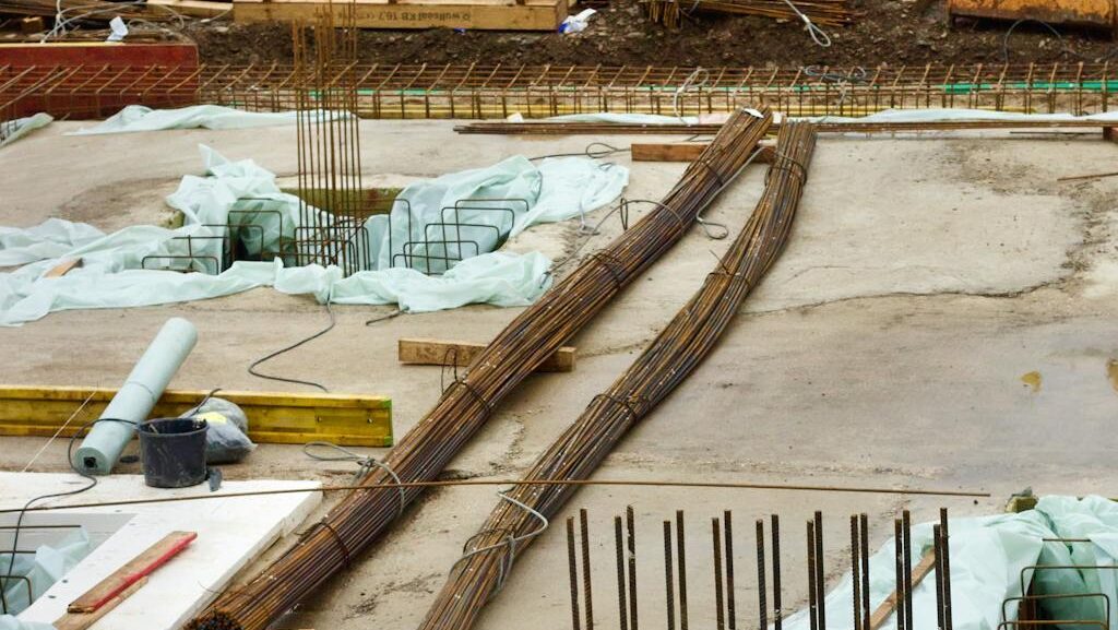 A detailed view of a commercial building foundation under construction with steel rebar reinforcement.